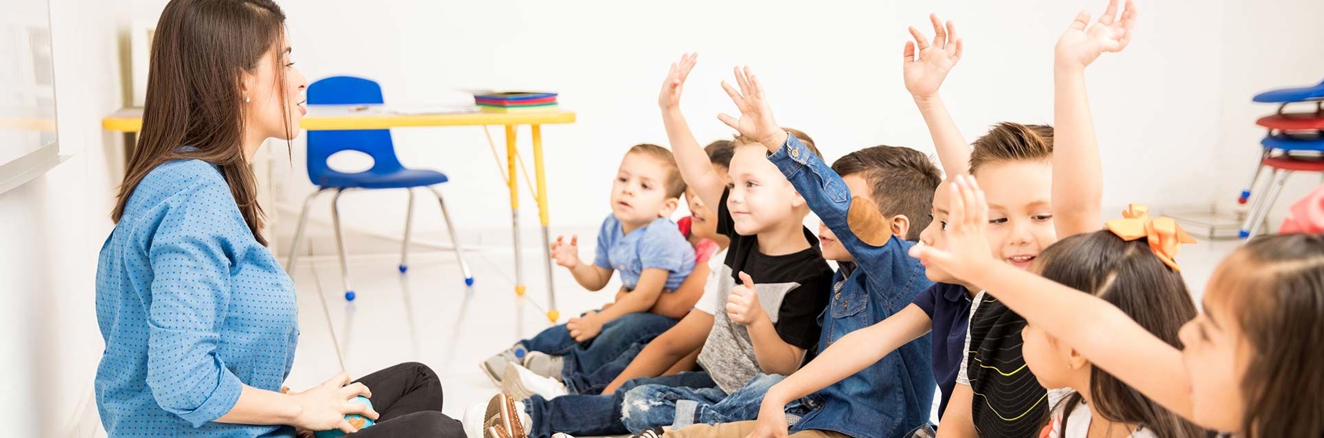 preschoolers raising hands